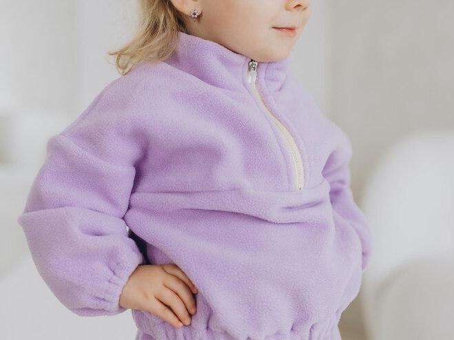 Little girl wearing purple jacket