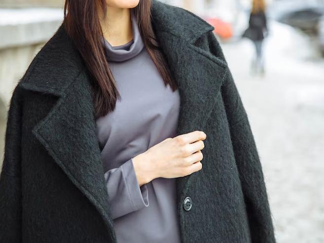 a woman in a sweater and coat