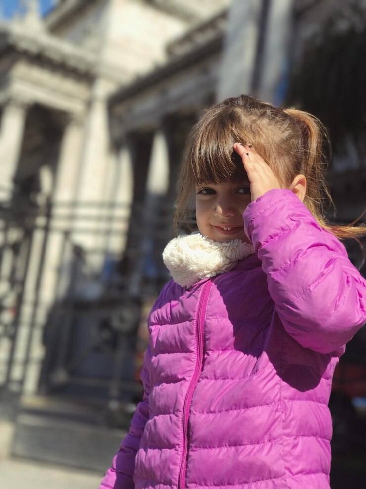 girl standing outdoors on sunny day