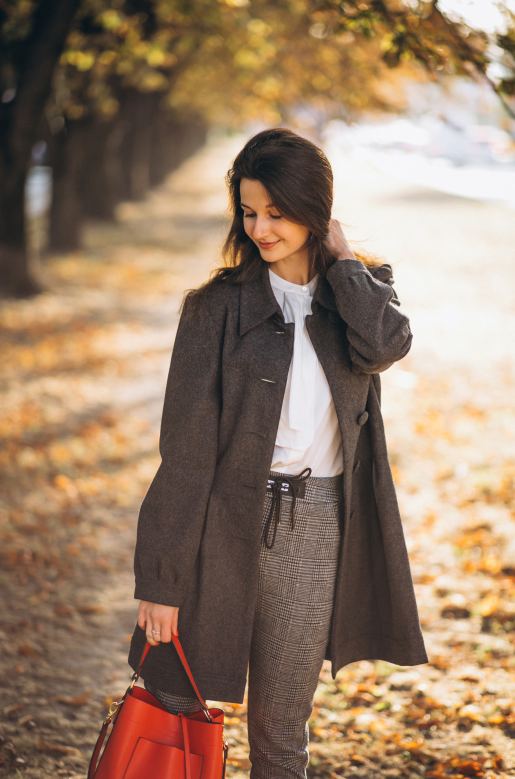 young-woman-walking-autumn-park wearing coat